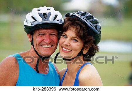 couple with bike helmets View Large Photo Image Stock Photograph - couple with bike helmets. Fotosearch