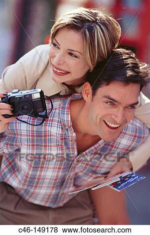 Stock Photo - Couple with camera. Fotosearch