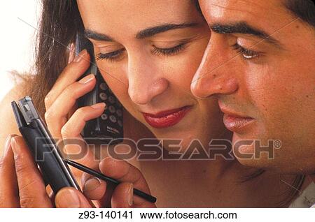Couple with cell phone and PDA View Large Photo Image Stock Image - Couple with cell phone and PDA. Fotosearch
