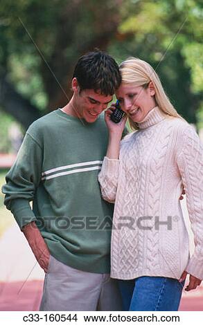 Picture - Couple with cell phone. Fotosearch