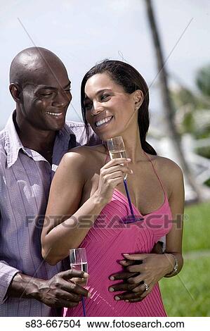 Picture - Couple with Champaigne outdoors. Fotosearch
