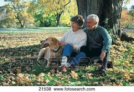 Stock Photo - Couple with dog, autumn. Fotosearch