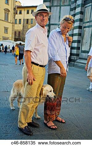 Stock Photography - Couple with dog in front of Santa Maria del Fiore cathedral, Florence, Tuscany, Italy. Fotosearch