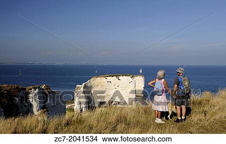 Couple with Dog looking over Old Harry Rocks Jurassic Coast Isle of Purbeck Dorset England. View Large Photo Image Picture - Couple with Dog looking over Old Harry Rocks Jurassic Coast Isle of Purbeck Dorset England.. Fotosearch