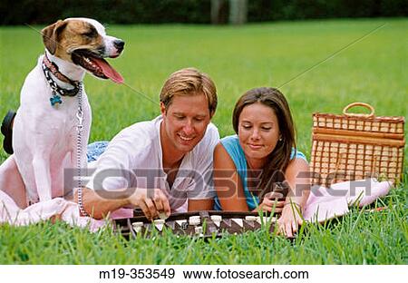 Couple with dog playing backgammon View Large Photo Image Stock Photo - Couple with dog playing backgammon. Fotosearch