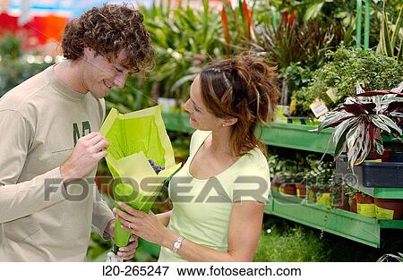 Couple with flower bouquet at shopping center View Large Photo Image Stock Photo - Couple with flower bouquet at shopping center. Fotosearch
