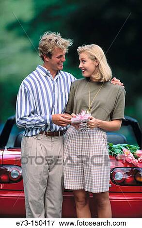 Couple with gift View Large Photo Image Stock Photo - Couple with gift. Fotosearch