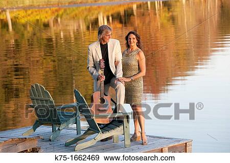 Couple with guitar on dock View Large Photo Image Stock Photo - Couple with guitar on dock. Fotosearch