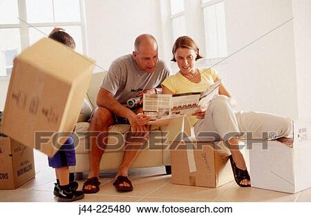 Couple with kid sitting on chair and boxes, looking at paint chart in their new house View Large Photo Image Stock Image - Couple with kid sitting on chair and boxes, looking at paint chart in their new house. Fotosearch