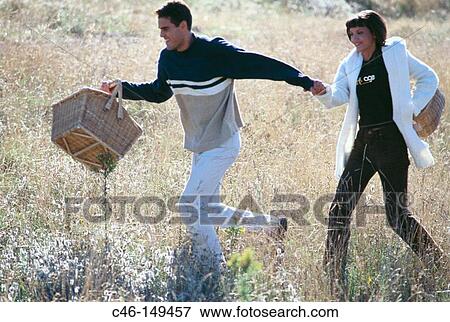 Stock Photo - Couple with picnic basket. Fotosearch