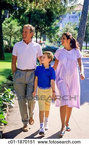 Couple with pregnant woman and boy strolling in park View Large Photo Image Stock Image - Couple with pregnant woman and boy strolling in park. Fotosearch