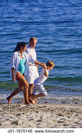 Couple with pregnant woman and boy strolling on beach View Large Photo Image Stock Photograph - Couple with pregnant woman and boy strolling on beach. Fotosearch