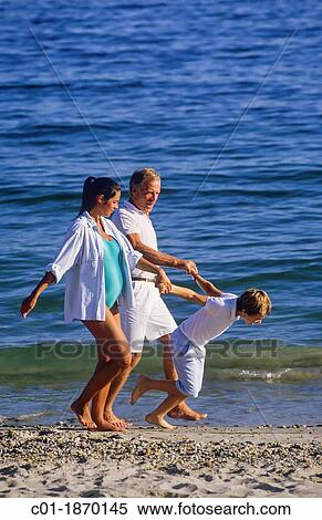 Couple with pregnant woman and boy strolling on beach View Large Photo Image Stock Photography - Couple with pregnant woman and boy strolling on beach. Fotosearch