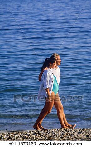 Couple with pregnant woman strolling on beach View Large Photo Image Stock Image - Couple with pregnant woman strolling on beach. Fotosearch