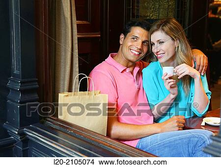 Picture - Couple with shopping bags in a coffee bar. San Sebastian. Donostia. Gipuzkoa. Basque Country. Spain.. Fotosearch