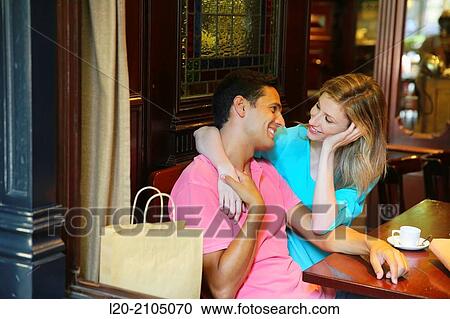Stock Image - Couple with shopping bags in a coffee bar. San Sebastian. Donostia. Gipuzkoa. Basque Country. Spain.. Fotosearch
