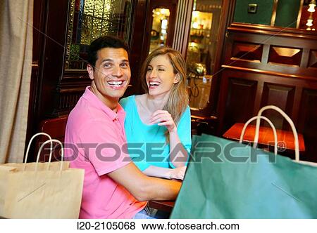 Stock Photo - Couple with shopping bags in a coffee bar. San Sebastian. Donostia. Gipuzkoa. Basque Country. Spain.. Fotosearch