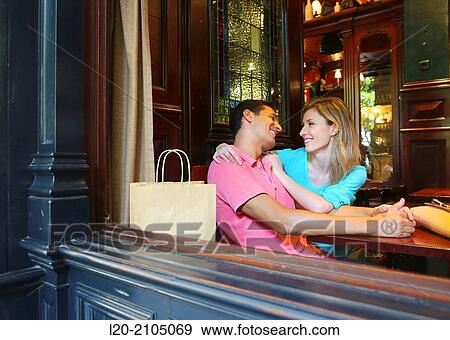 Stock Photo - Couple with shopping bags in a coffee bar. San Sebastian. Donostia. Gipuzkoa. Basque Country. Spain.. Fotosearch