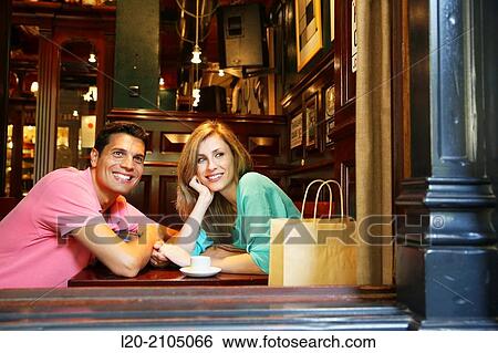 Stock Photograph - Couple with shopping bags in a coffee bar. San Sebastian. Donostia. Gipuzkoa. Basque Country. Spain.. Fotosearch