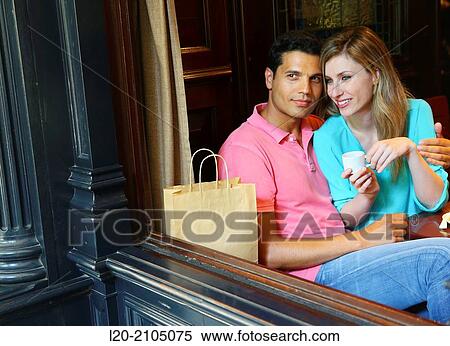 Stock Photography - Couple with shopping bags in a coffee bar. San Sebastian. Donostia. Gipuzkoa. Basque Country. Spain.. Fotosearch