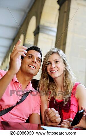Couple with smartphone at a restaurant. San Sebastian. Donostia. Gipuzkoa. Basque Country. Spain. View Large Photo Image Stock Image - Couple with smartphone at a restaurant. San Sebastian. Donostia. Gipuzkoa. Basque Country. Spain.. Fotosearch