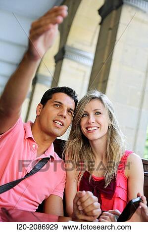 Couple with smartphone at a restaurant. San Sebastian. Donostia. Gipuzkoa. Basque Country. Spain. View Large Photo Image Stock Photo - Couple with smartphone at a restaurant. San Sebastian. Donostia. Gipuzkoa. Basque Country. Spain.. Fotosearch