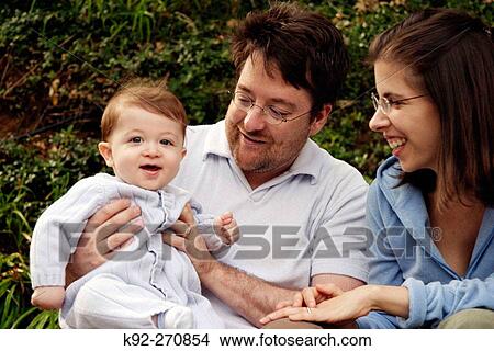Couple with their 7-month-old baby View Large Photo Image Picture - Couple with their 7-month-old baby. Fotosearch