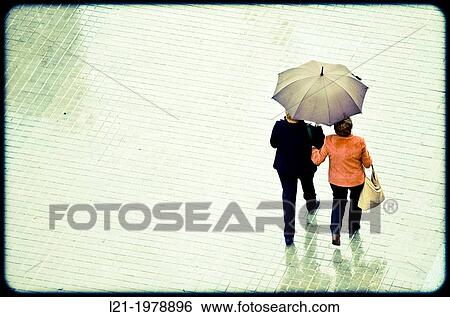 Couple with umbrella walking down the street. Viewpoint from above. Barcelona, Catalonia, Spain. View Large Photo Image Stock Photograph - Couple with umbrella walking down the street. Viewpoint from above. Barcelona, Catalonia, Spain.. Fotosearch