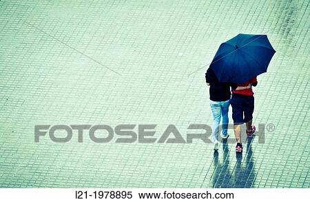 Couple with umbrella walking down the street. Viewpoint from above. Barcelona, Catalonia, Spain. View Large Photo Image Stock Photography - Couple with umbrella walking down the street. Viewpoint from above. Barcelona, Catalonia, Spain.. Fotosearch