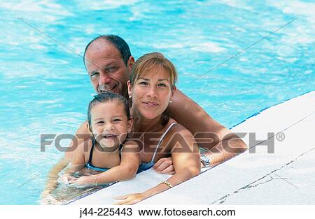 Couple with young girl in the pool View Large Photo Image Stock Image - Couple with young girl in the pool. Fotosearch