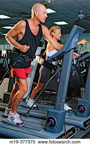 couple working out in at a health club View Large Photo Image Stock Photography - couple working out in at a health club. Fotosearch