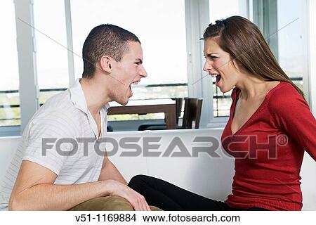 Couple yelling to each other at home View Large Photo Image Picture - Couple yelling to each other at home. Fotosearch