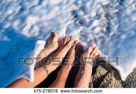 couple's feet in the surf View Large Photo Image Stock Photo - couple's feet in the surf. Fotosearch