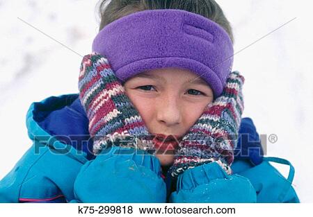 Stock Photo - covering up against the cold of winter. Fotosearch