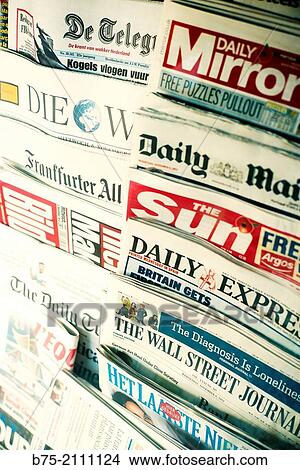 Picture - Covers of British newspapers in a kiosk. Telegraph, Daily Mirror, Daily Mail, The Sun, The Wall Street Journal, Die Welt, The Daily Telegraph. Barcelona, Spain, Europe.. Fotosearch