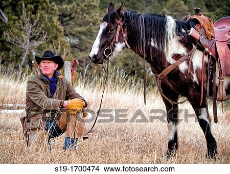 Cowboy and horse resting View Large Photo Image Picture - Cowboy and horse resting. Fotosearch