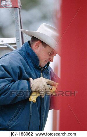 Cowboy building corral with drill. Texas. USA View Large Photo Image Stock Image - Cowboy building corral with drill. Texas. USA. Fotosearch
