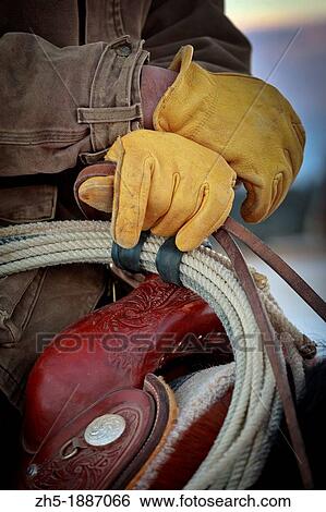 Cowboy in saddle with yellow leather gloves View Large Photo Image Stock Photograph - Cowboy in saddle with yellow leather gloves. Fotosearch