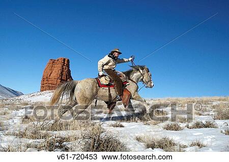 Cowboy out for a ride in winter, Shell, Wyoming. Usa View Large Photo Image Stock Image - Cowboy out for a ride in winter, Shell, Wyoming. Usa. Fotosearch