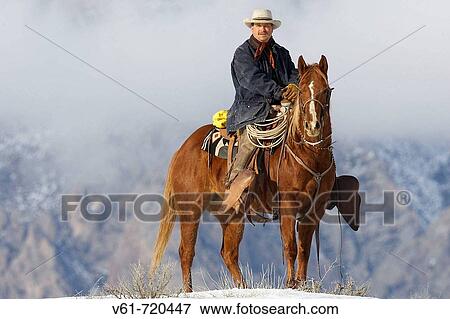 Stock Photo - Cowboy out for a ride in winter, Shell, Wyoming. Usa. Fotosearch