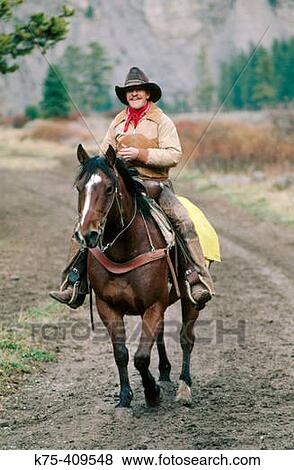 Cowboy riding his horse View Large Photo Image Stock Photo - Cowboy riding his horse. Fotosearch