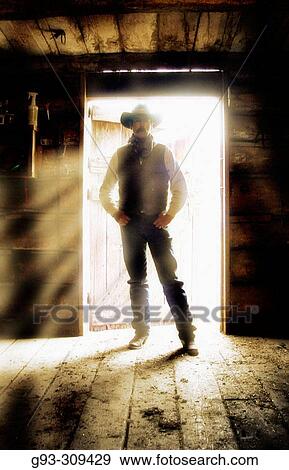 Cowboy standing in doorway View Large Photo Image Stock Photo - Cowboy standing in doorway. Fotosearch