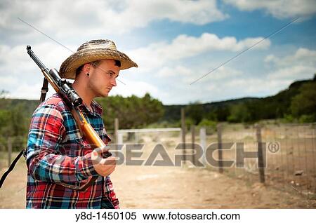 Cowboy with hunting rifle View Large Photo Image Stock Photography - Cowboy with hunting rifle. Fotosearch