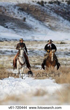 Picture - Cowboys out for a ride in winter, Shell, Wyoming. Usa. Fotosearch