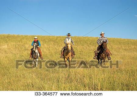 Cowboys riding the range. Montana. USA View Large Photo Image Stock Photo - Cowboys riding the range. Montana. USA. Fotosearch