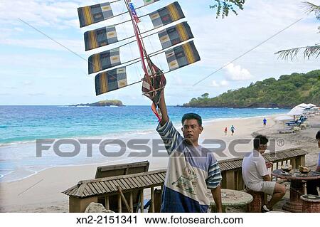 Craftsman displays handmade kite on the beach in Kuta Beach, Bali, Indonesia View Large Photo Image Stock Image - Craftsman displays handmade kite on the beach in Kuta Beach, Bali, Indonesia. Fotosearch
