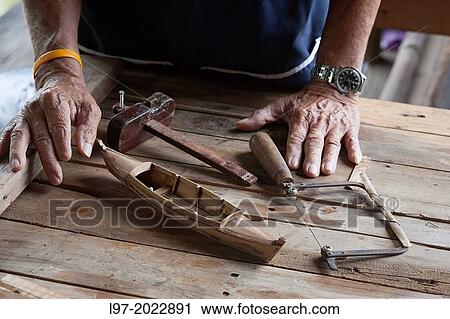 Craftsmans hands with a minature traditional Thai sampan made from teak wood, Bangkok Thailand. View Large Photo Image Stock Image - Craftsmans hands with a minature traditional Thai sampan made from teak wood, Bangkok Thailand.. Fotosearch