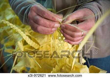 Stock Image - Craftswoman making with palm leaves Elche Alicante Spain. Fotosearch