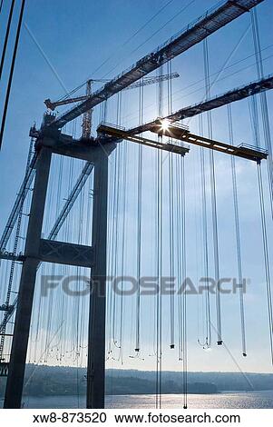 Stock Image - Crane on top of west tower of the new Tacoma Narrows Bridge during bridge construction. Fotosearch