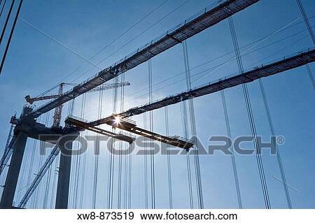 Crane on top of west tower of the new Tacoma Narrows Bridge during bridge construction View Large Photo Image Stock Photo - Crane on top of west tower of the new Tacoma Narrows Bridge during bridge construction. Fotosearch